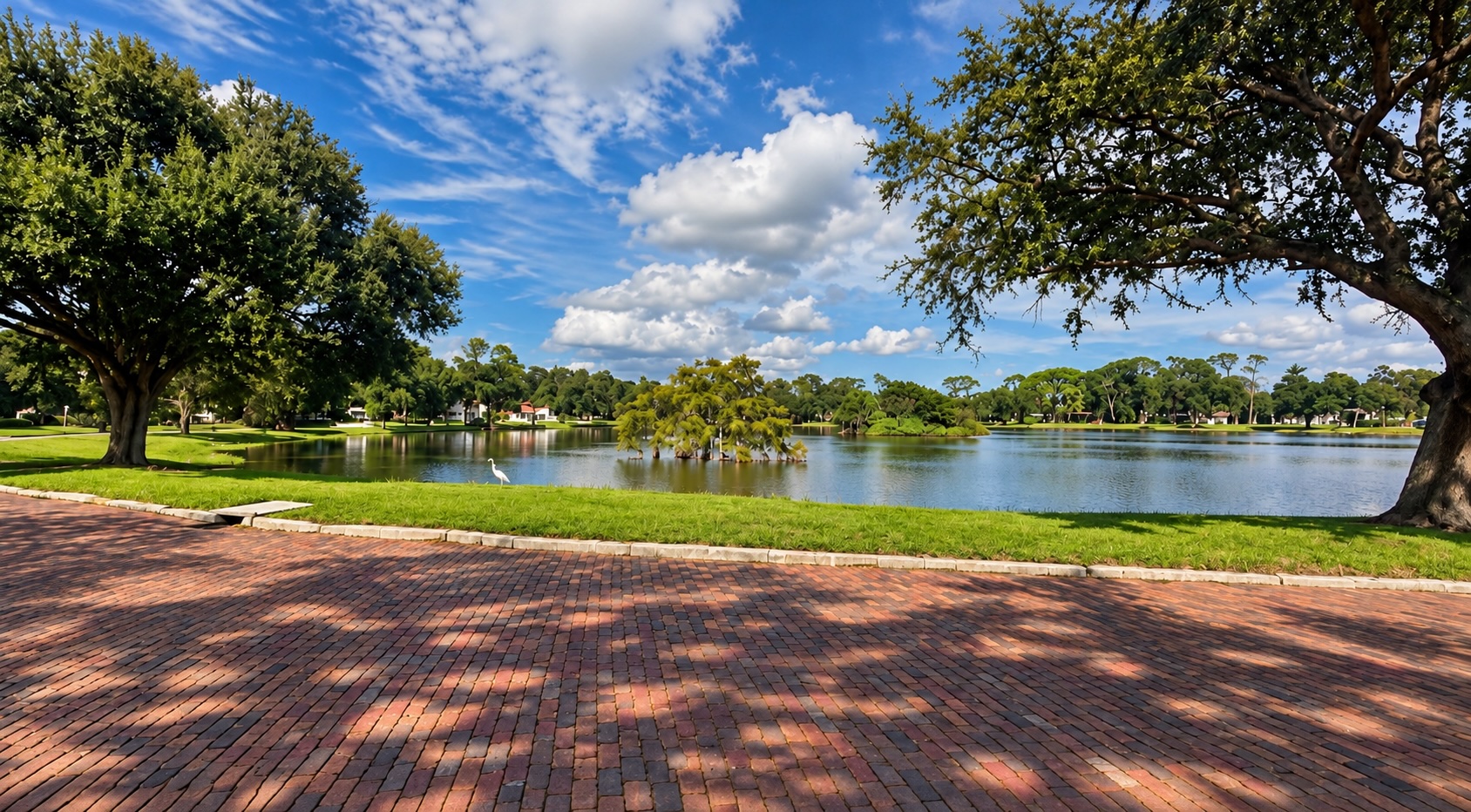 Lake Pasadena in St. Petersburg, with brick paving, mature trees, and a cypress standing in the water